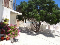 The traditional square Mpechraki in Kastro, Chora with flowers, trees and spreaded clothes